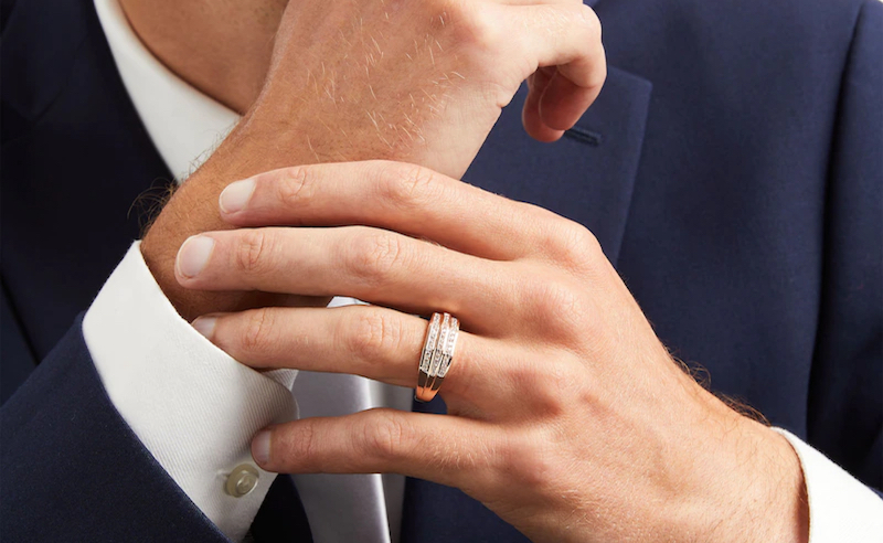 Man wearing a suit and a ring on his finger